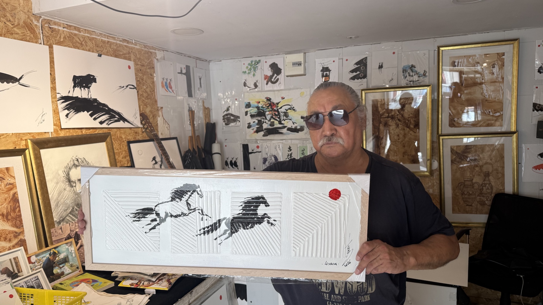 Rouslam Botiev holding a complete two-horse original in his Alfama atelier